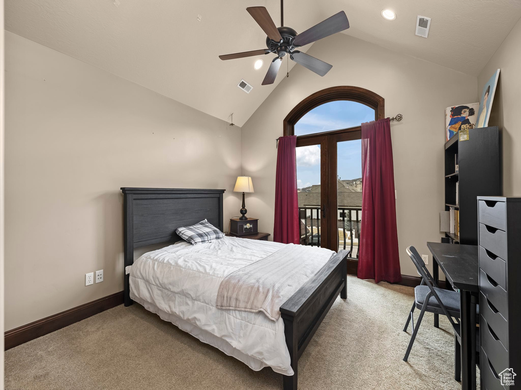 Carpeted bedroom featuring vaulted ceiling, access to exterior, and ceiling fan