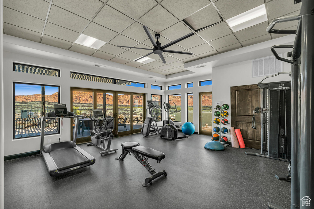 Workout area featuring a paneled ceiling and ceiling fan