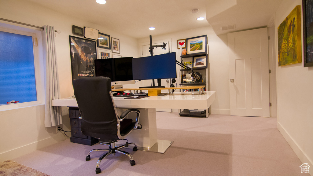 Carpeted home office with built in desk