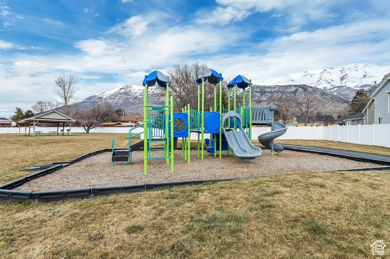 View of playground featuring a yard, a mountain view, and a gazebo