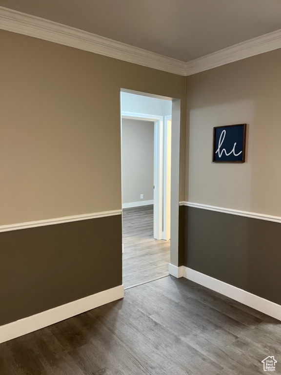 Unfurnished room with dark hardwood / wood-style flooring and crown molding