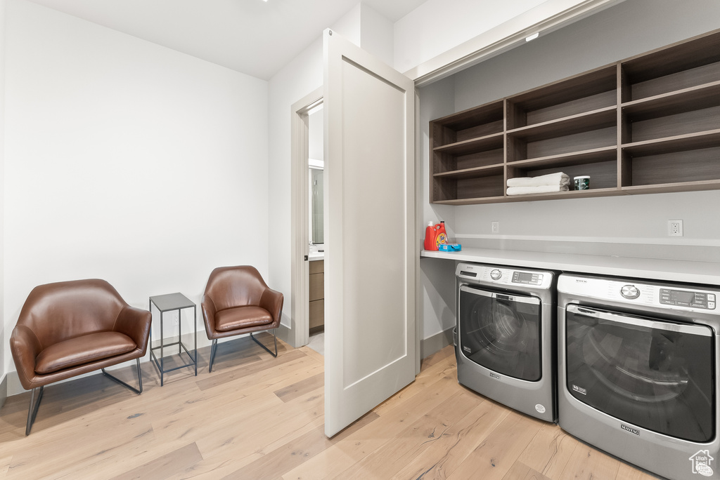 Laundry area featuring separate washer and dryer and light hardwood / wood-style floors