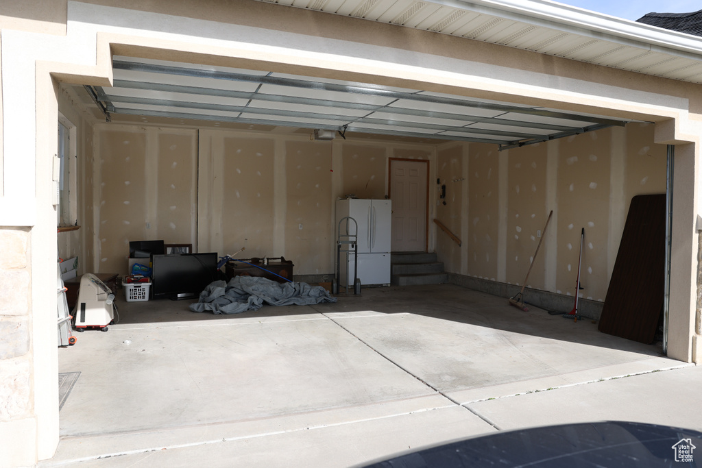 Garage featuring white fridge