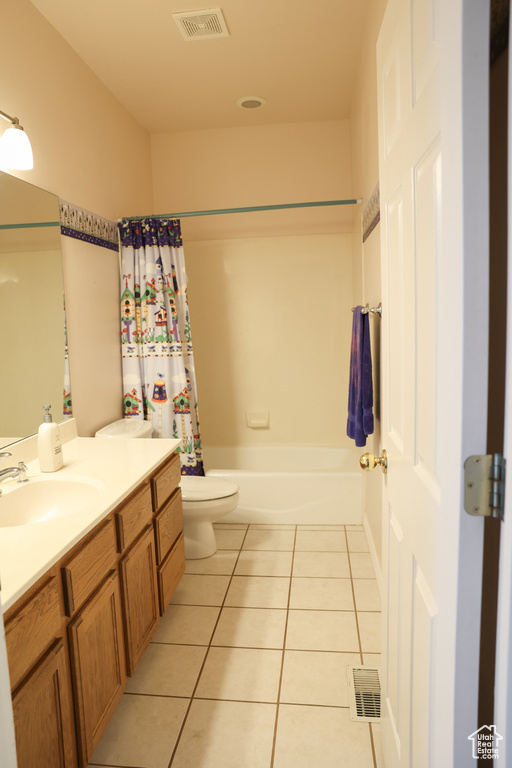 Full bathroom with vanity, tile flooring, shower / bath combo, and toilet