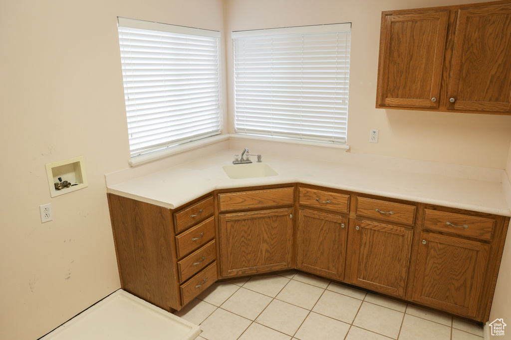 Kitchen with light tile floors and sink