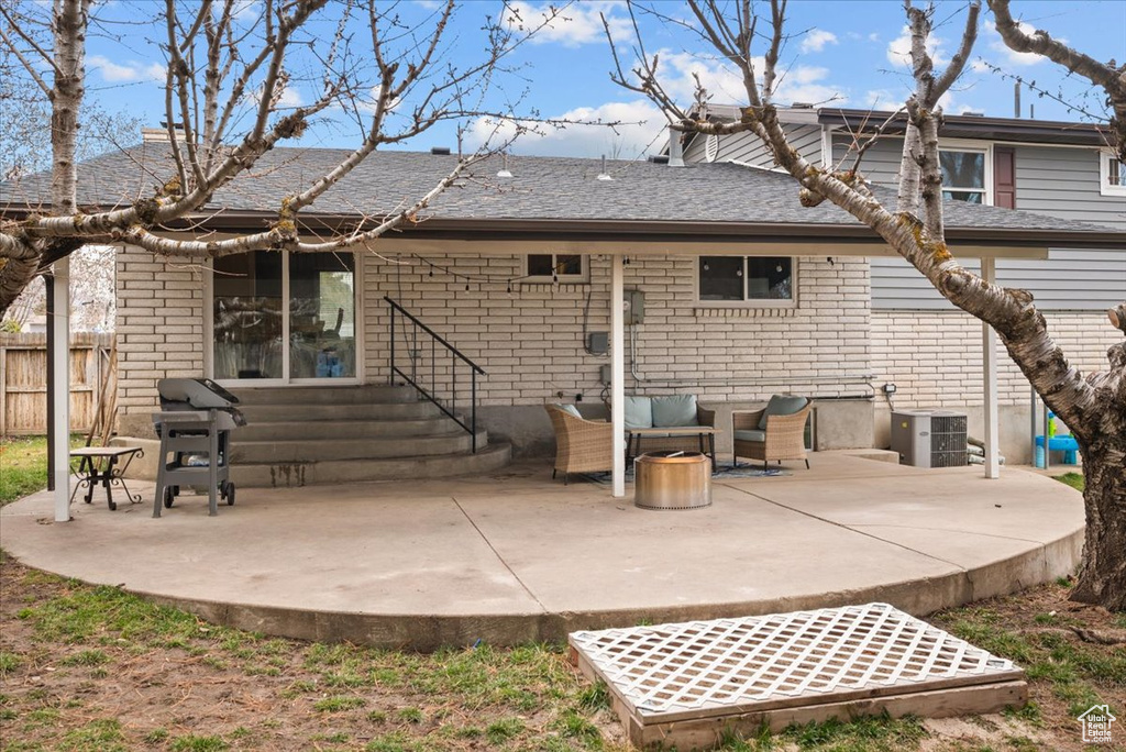 Back of property featuring a patio area, central AC unit, and an outdoor hangout area