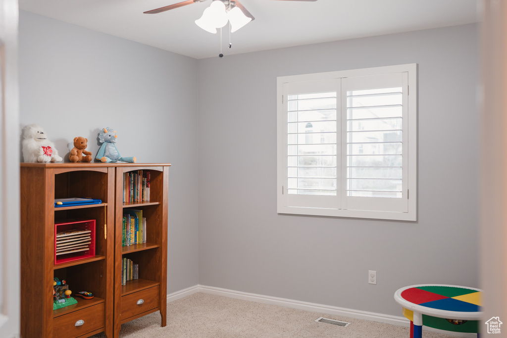 Misc room featuring light colored carpet and ceiling fan