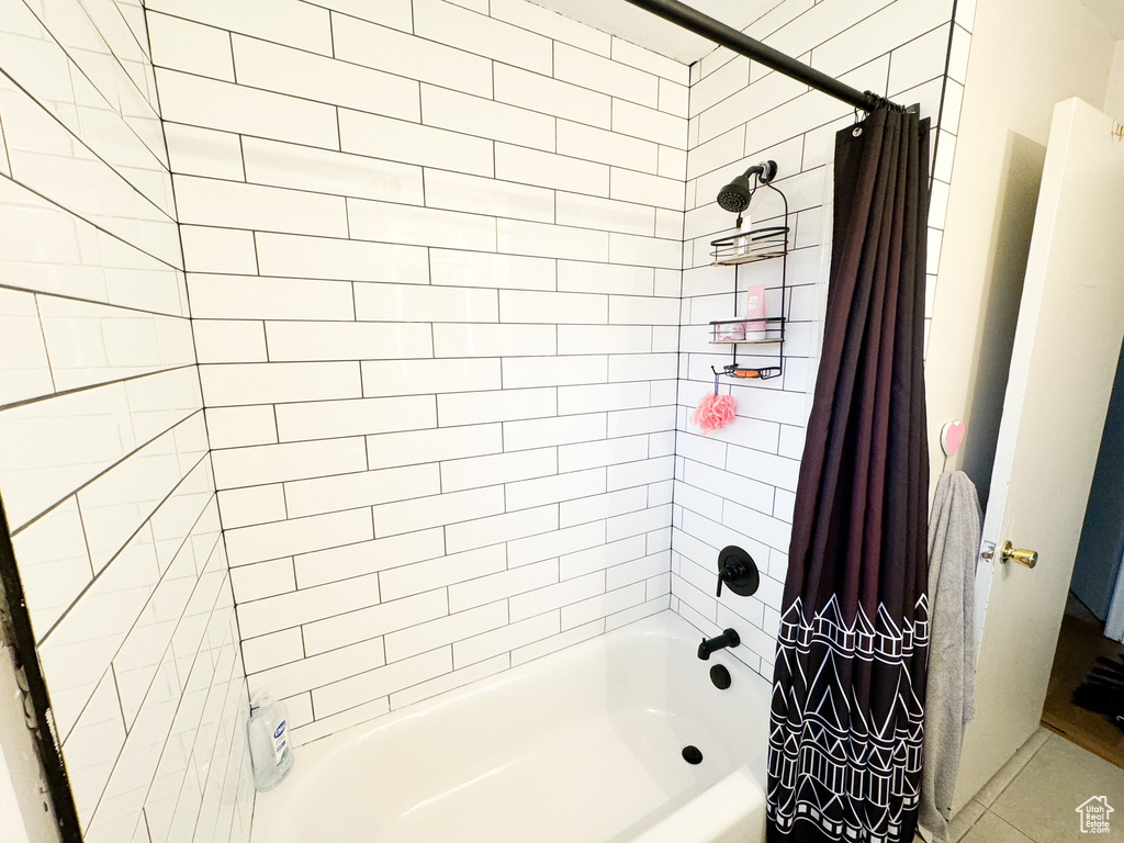 Bathroom with shower / bathtub combination with curtain and tile floors