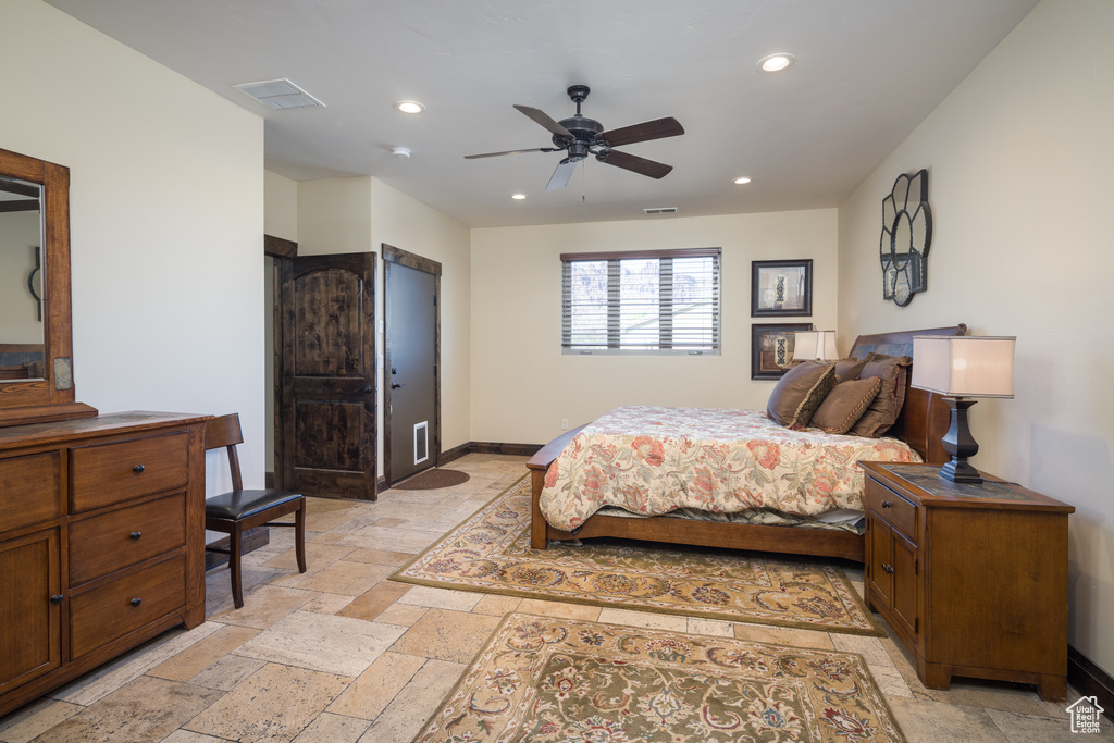 Bedroom featuring light tile flooring and ceiling fan