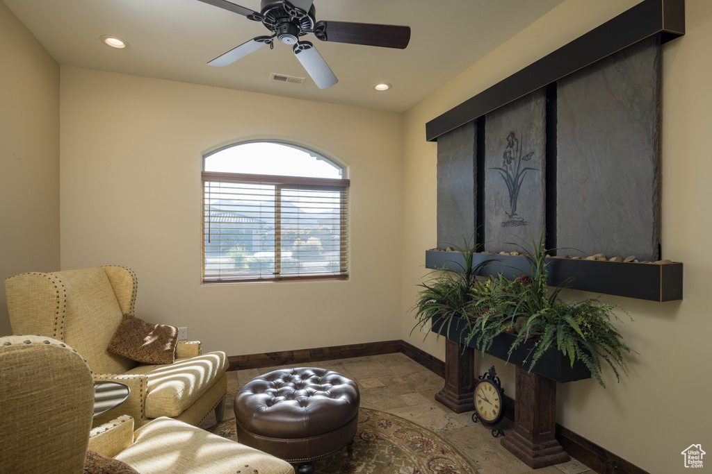 Living area with light tile floors and ceiling fan