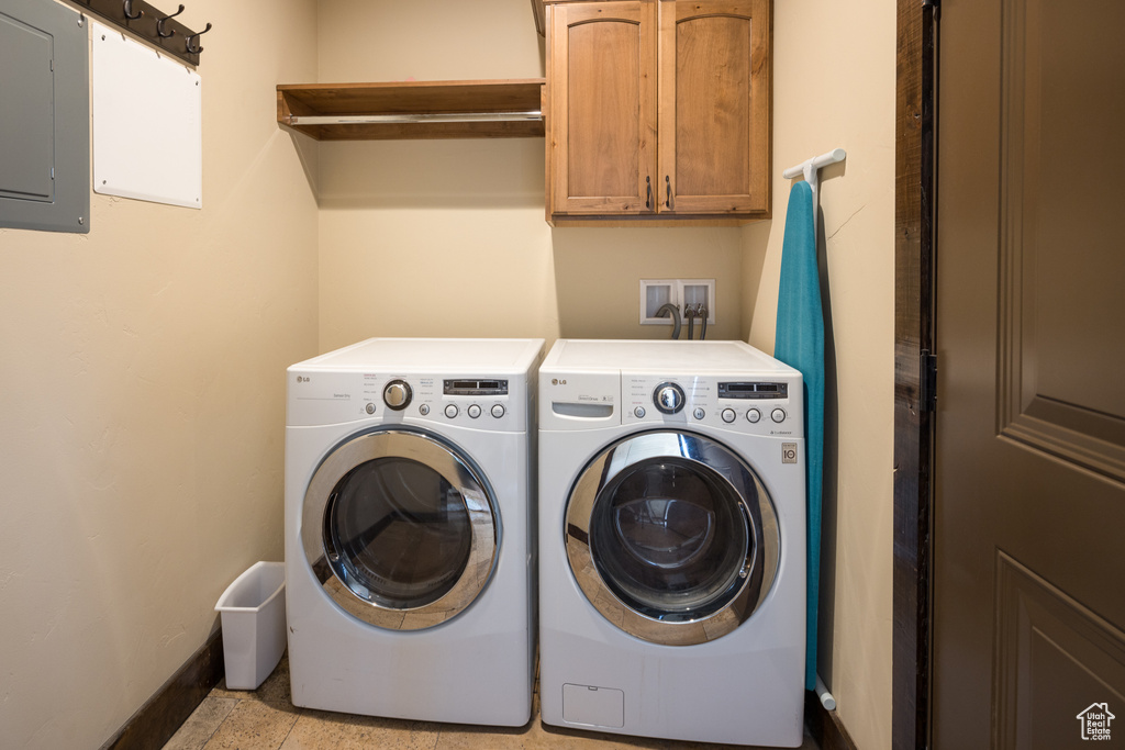 Clothes washing area featuring separate washer and dryer, light tile floors, cabinets, and hookup for a washing machine