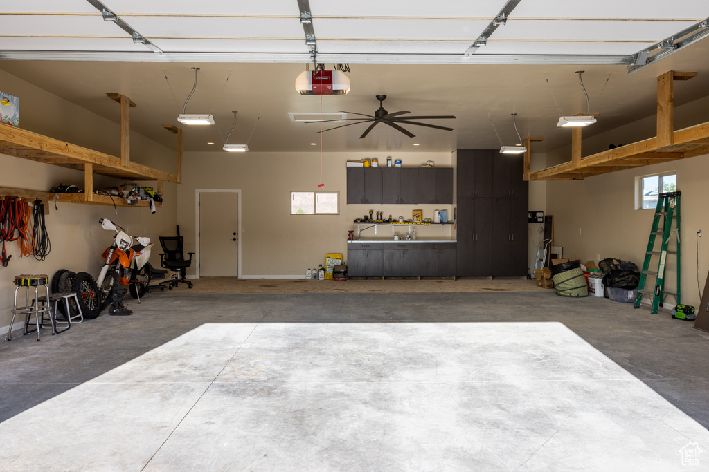 Garage featuring a garage door opener and ceiling fan