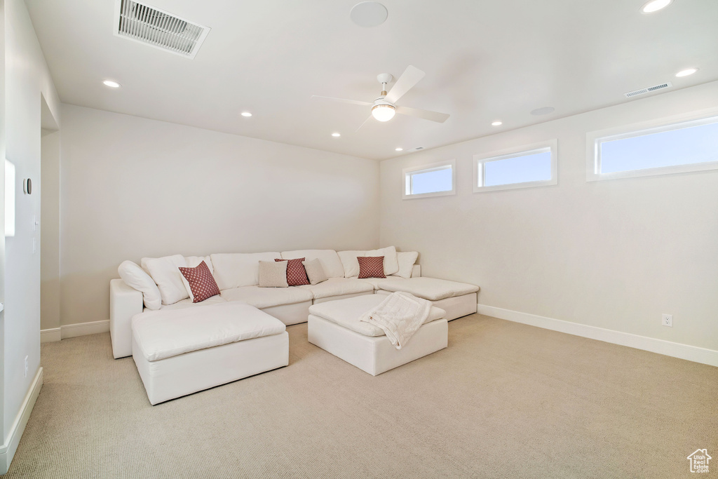 Living room featuring light carpet and ceiling fan
