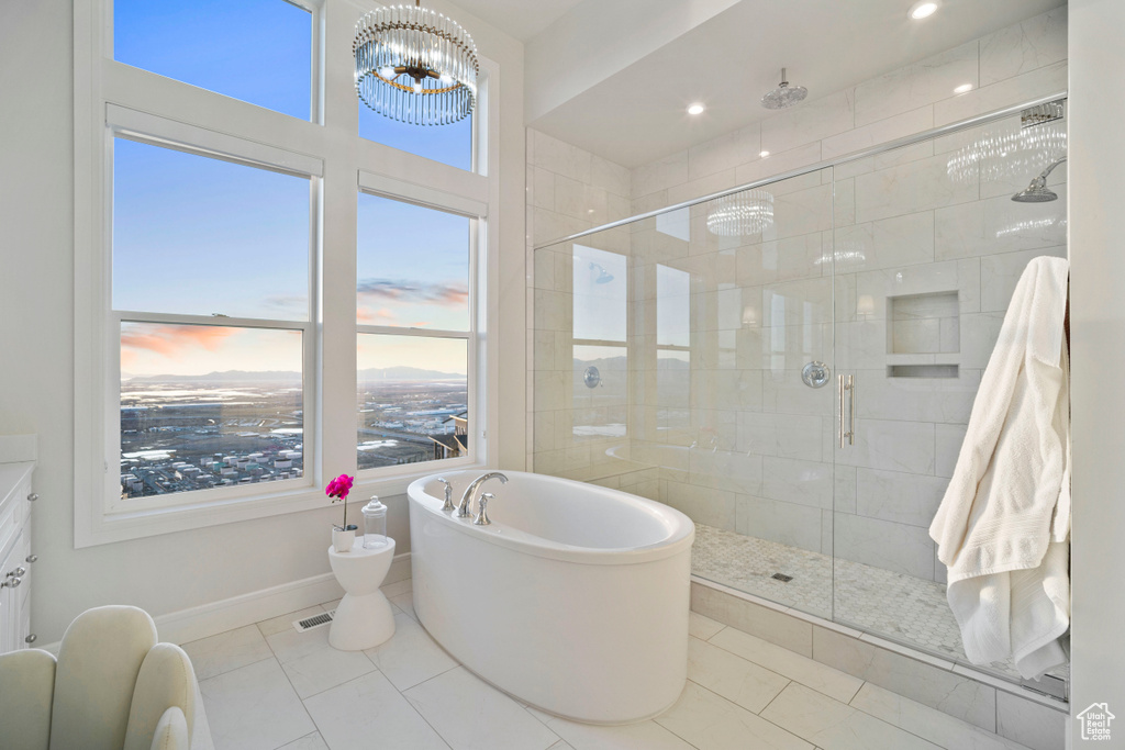 Bathroom featuring vanity, shower with separate bathtub, a bidet, tile flooring, and an inviting chandelier