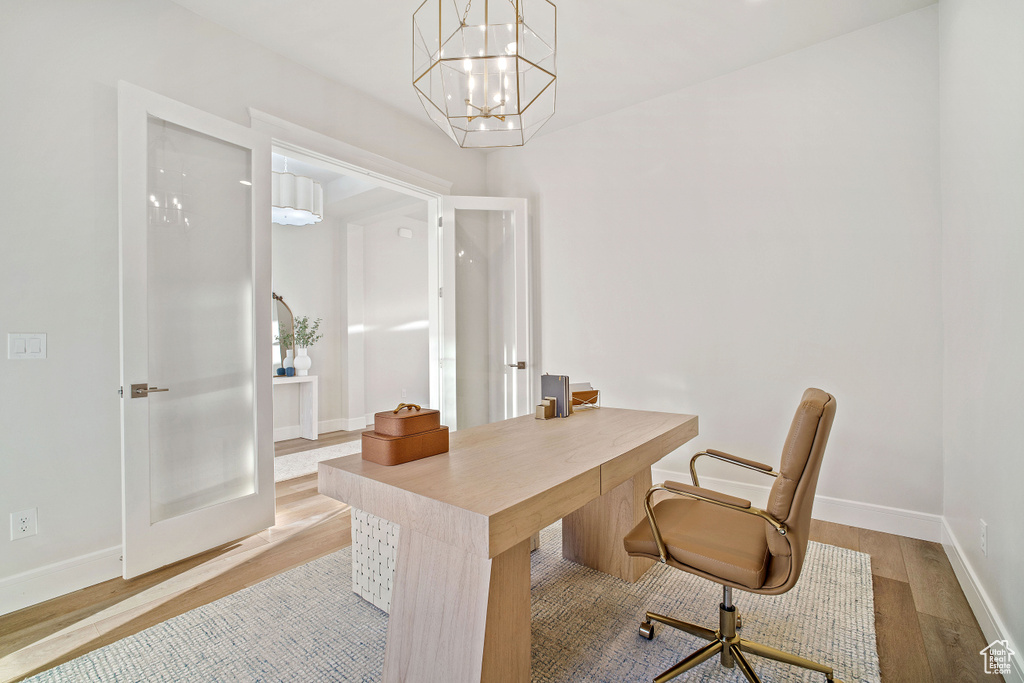 Office featuring a notable chandelier and light hardwood / wood-style flooring