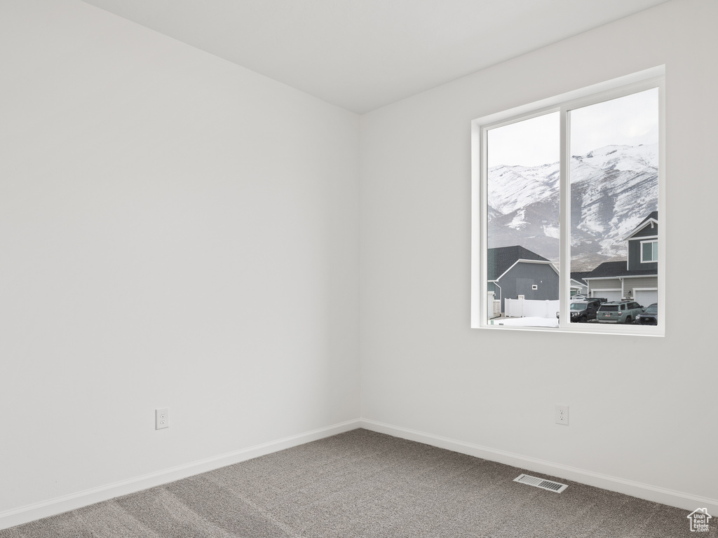 Empty room with a mountain view and carpet