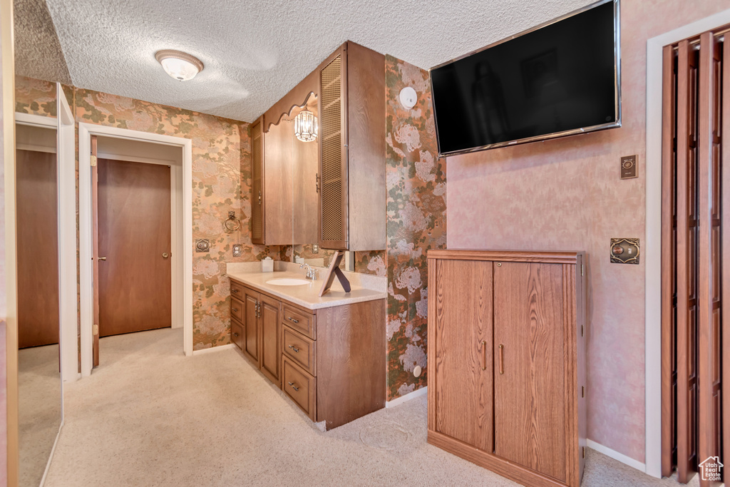 Bathroom with vanity and a textured ceiling