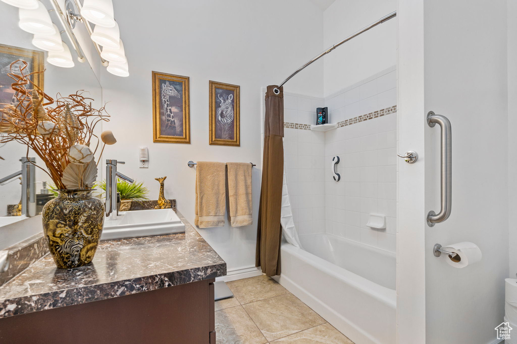 Bathroom featuring vanity, tile flooring, and shower / bathtub combination with curtain