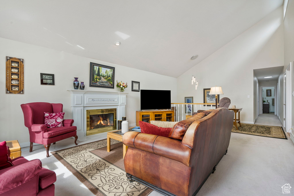 Carpeted living room with high vaulted ceiling