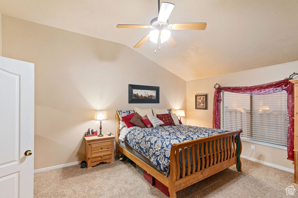Bedroom featuring lofted ceiling, light carpet, and ceiling fan