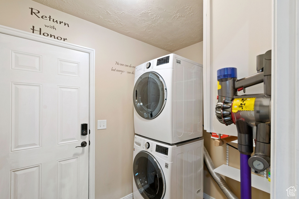 Clothes washing area featuring stacked washer / drying machine