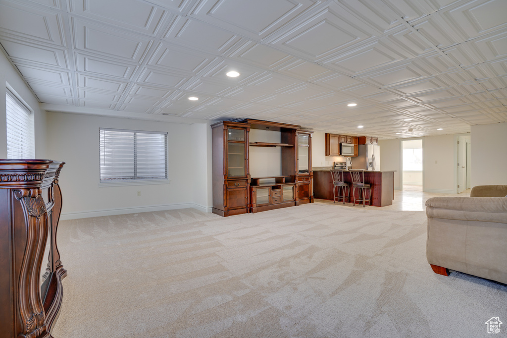 Carpeted living room with bar