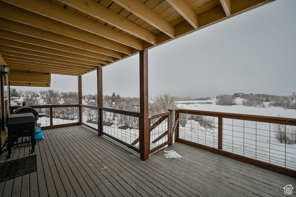 Snow covered deck with grilling area