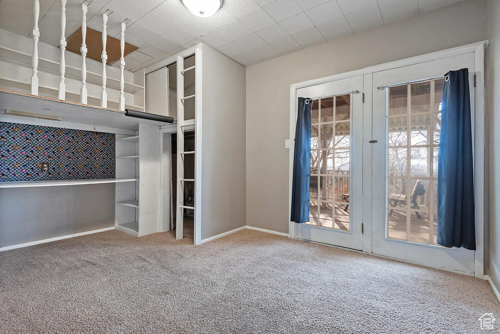 Interior space featuring light carpet and french doors