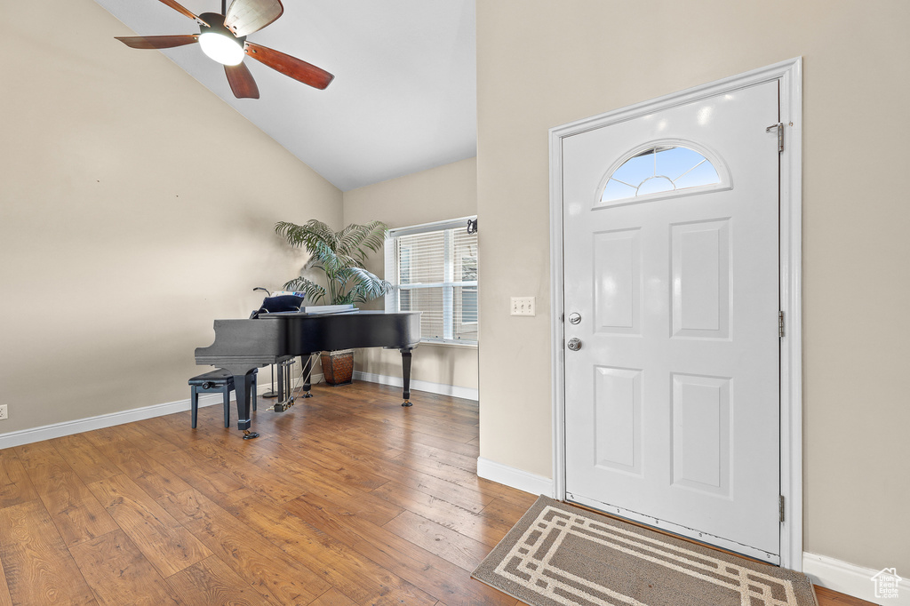 Foyer featuring a wealth of natural light, high vaulted ceiling, ceiling fan, and dark wood-type flooring