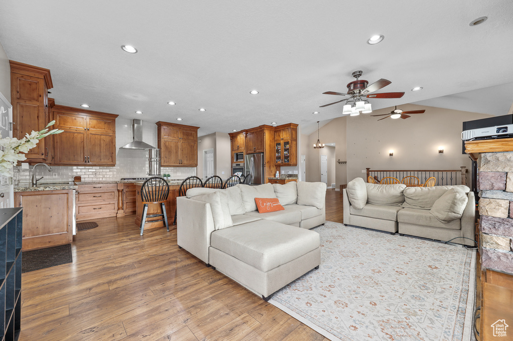 Living room featuring light hardwood / wood-style floors, sink, and ceiling fan