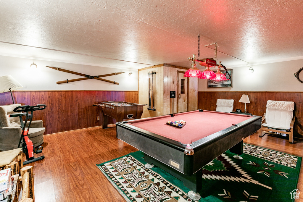 Recreation room with a textured ceiling, billiards, and dark wood-type flooring