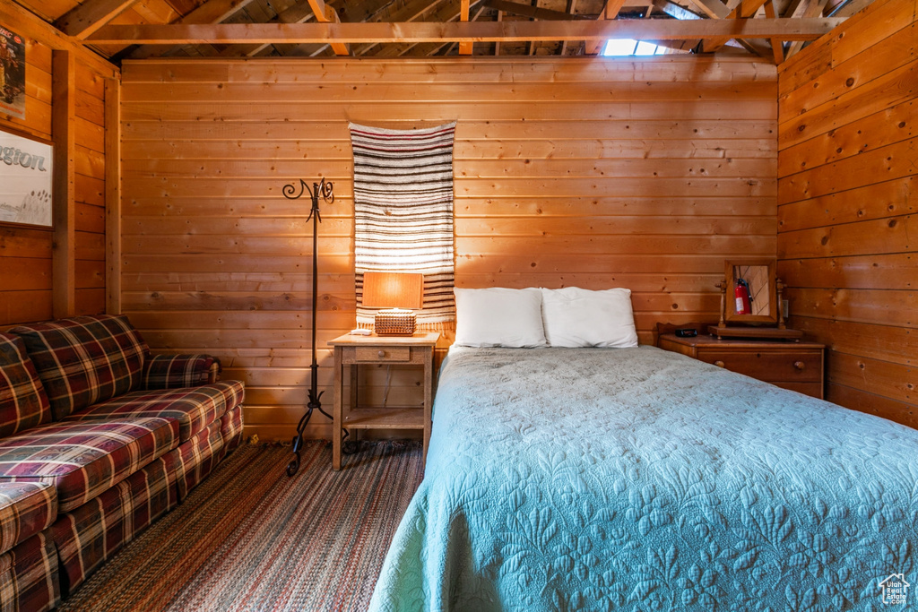 Bedroom featuring wooden walls