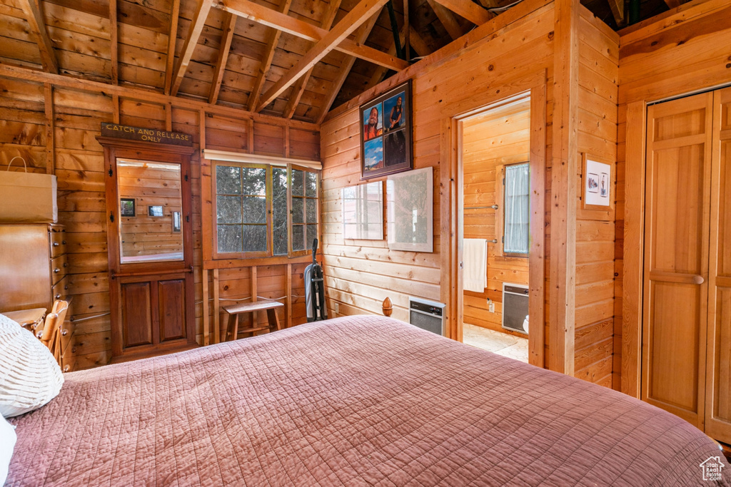 Unfurnished bedroom featuring wooden walls, wooden ceiling, and vaulted ceiling with beams