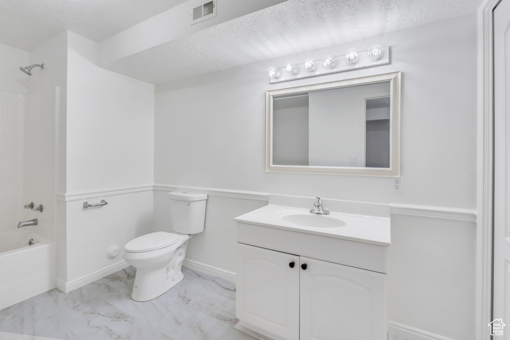 Full bathroom featuring shower / bath combination, tile floors, toilet, and vanity