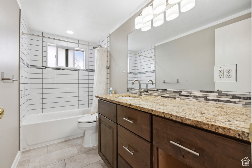 Full bathroom featuring vanity, toilet, shower / bath combination with curtain, backsplash, and crown molding