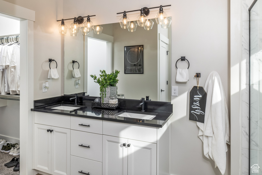 Bathroom with double vanity and an inviting chandelier
