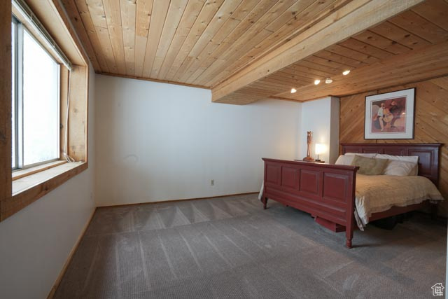 Carpeted bedroom with wood ceiling