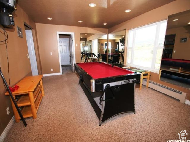 Playroom featuring a baseboard radiator, billiards, and carpet floors
