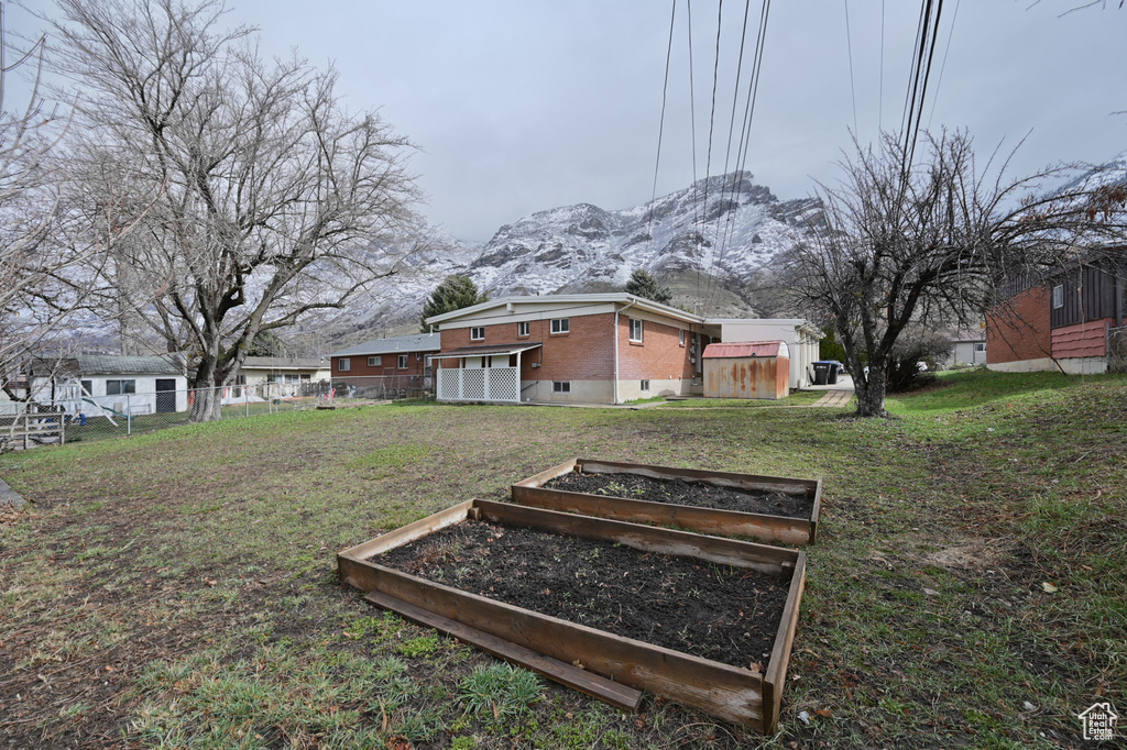 View of yard featuring a mountain view and an outdoor structure