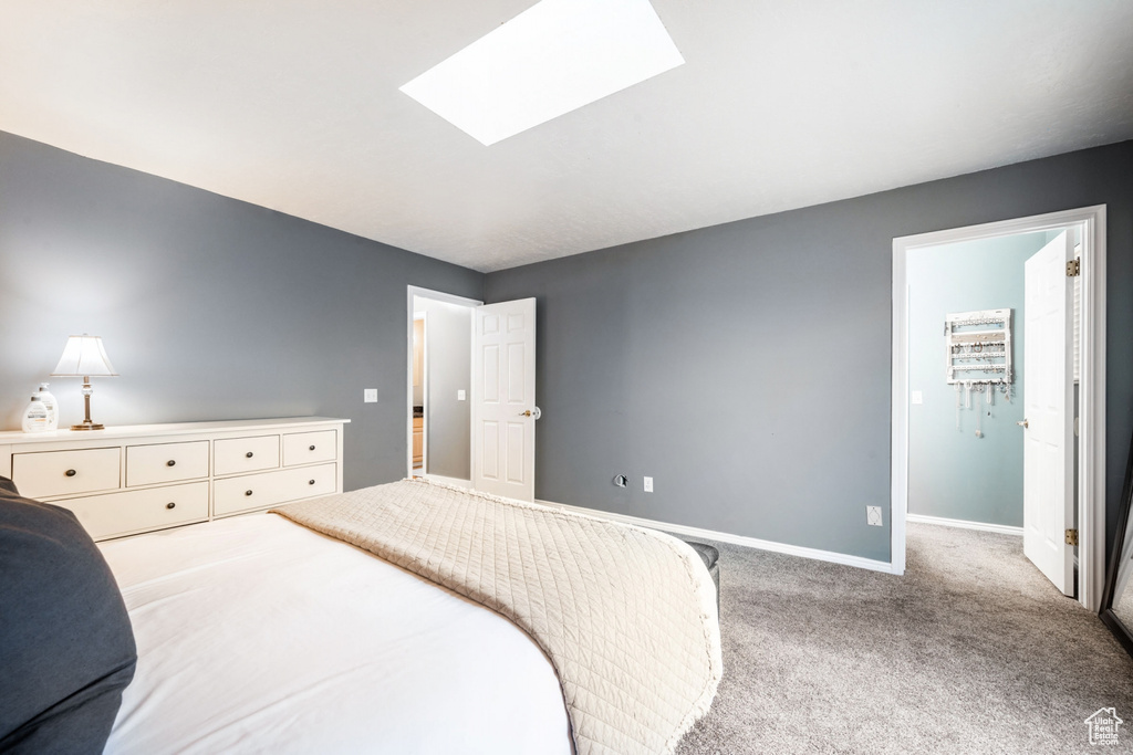 Bedroom featuring carpet flooring and a skylight