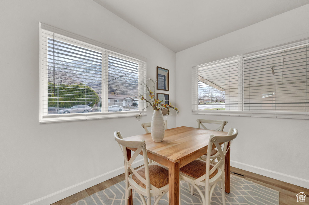 Dining space featuring a wealth of natural light and hardwood / wood-style floors