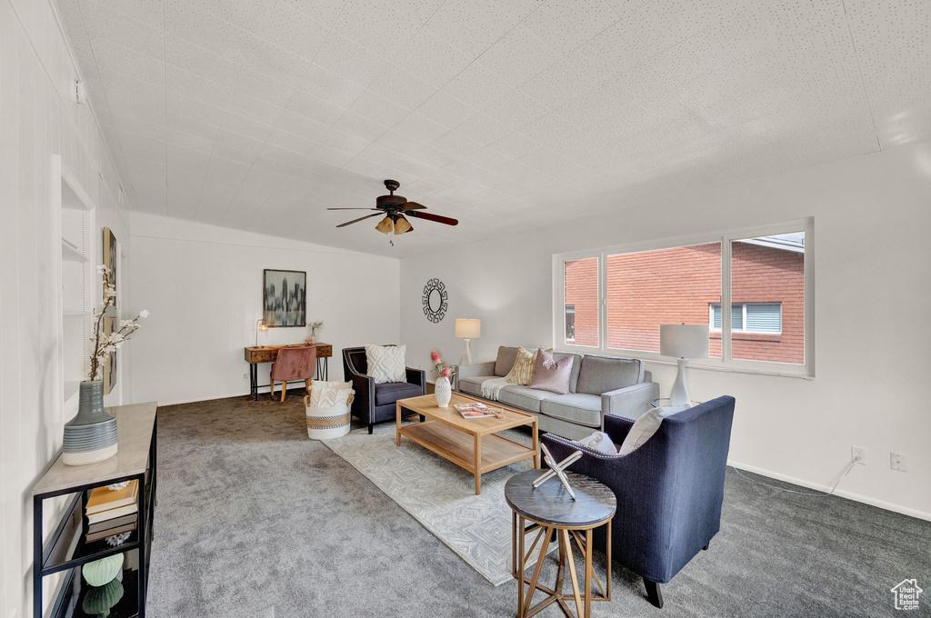 Living room with dark carpet and ceiling fan