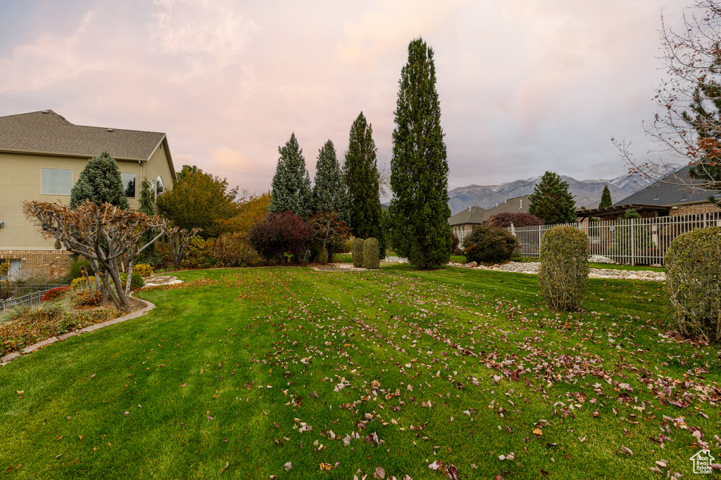 Yard at dusk featuring a mountain view