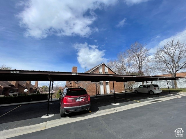 View of vehicle parking featuring a carport
