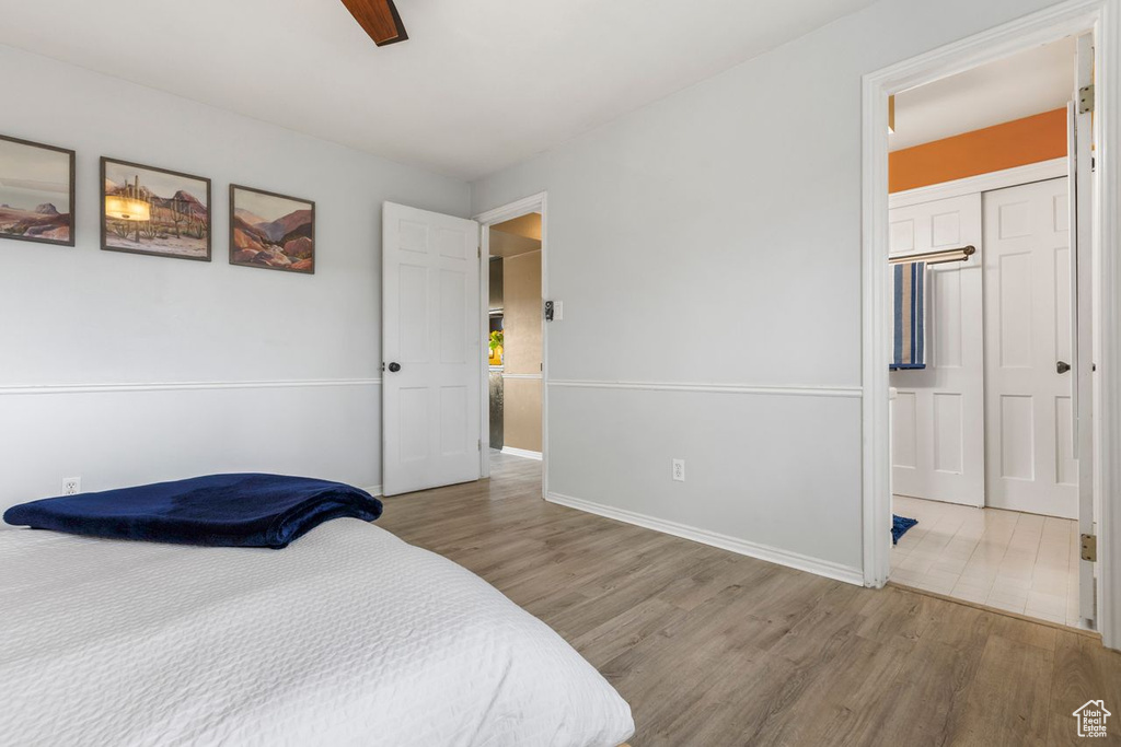 Bedroom featuring light wood-type flooring, a closet, and ceiling fan