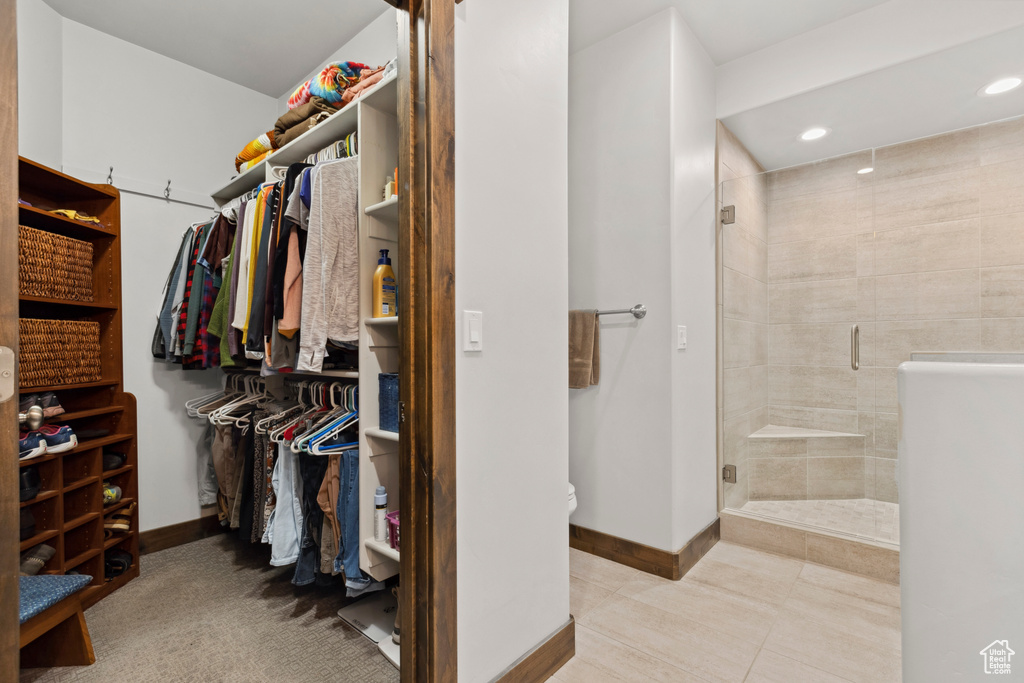 Spacious closet featuring light tile floors