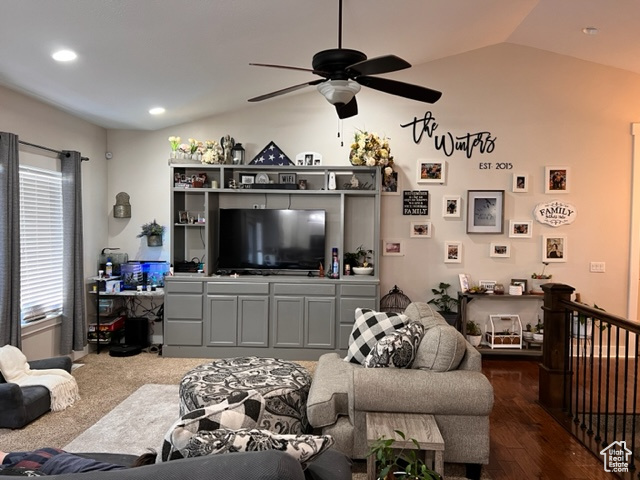 Living room with vaulted ceiling, ceiling fan, and carpet flooring
