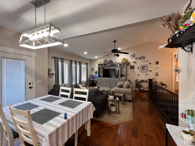 Dining room featuring lofted ceiling, dark hardwood floors, and ceiling fan