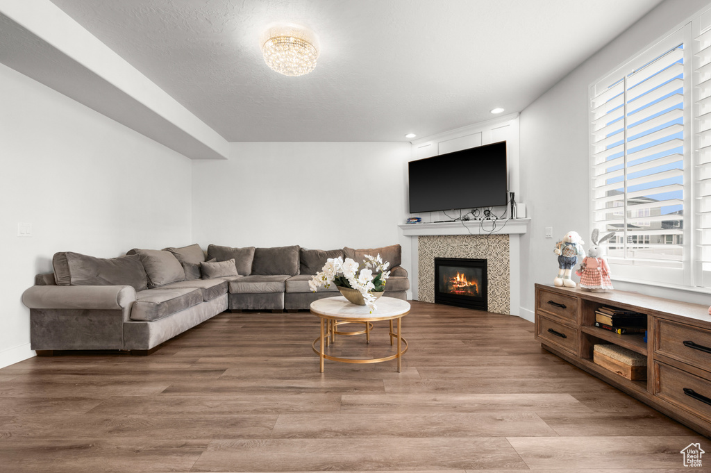 Living room featuring a tile fireplace and hardwood / wood-style flooring