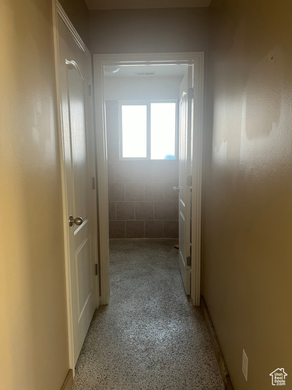 Corridor featuring light carpet